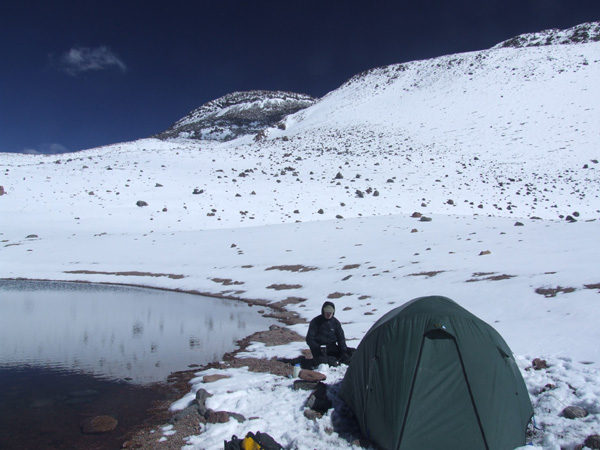 the high camp at 5935m in the col between Tres Cruces Sur and Tres Cruces Central beside a pool of water 